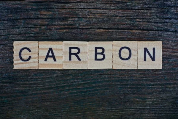 Word Carbon Made Wooden Gray Letters Lies Gray Background — Stock Photo, Image