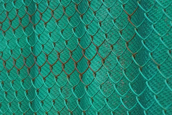 metal texture of green iron rusty mesh on fence wall