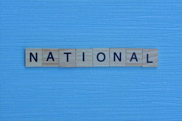 Grijs Woord Nationaal Van Kleine Houten Letters Een Blauwe Tafel — Stockfoto
