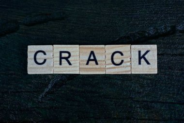 Gri kelime siyah bir masanın üzerindeki küçük tahta harflerden çatırtı.