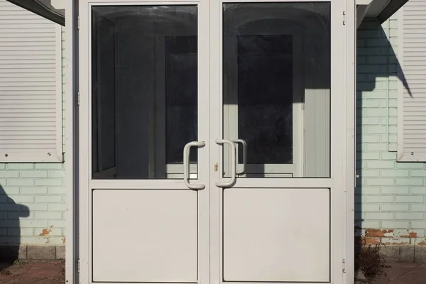 Closed White Doors Made Plastic Metal Glass Street Green Brick — 스톡 사진