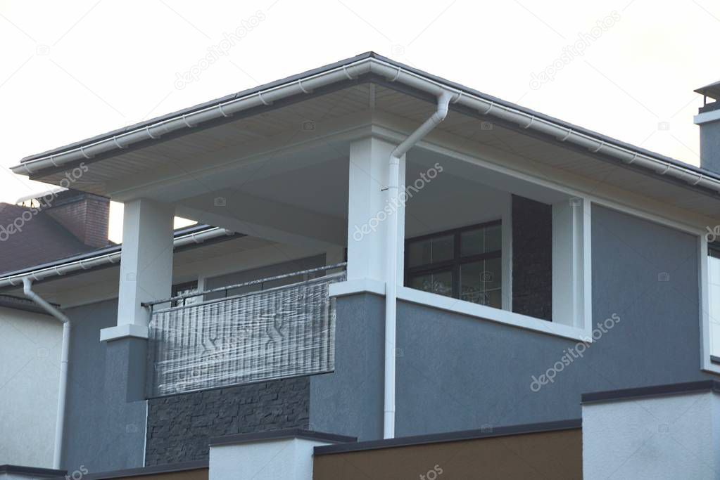 large gray white open balcony made of concrete and metal on a private house