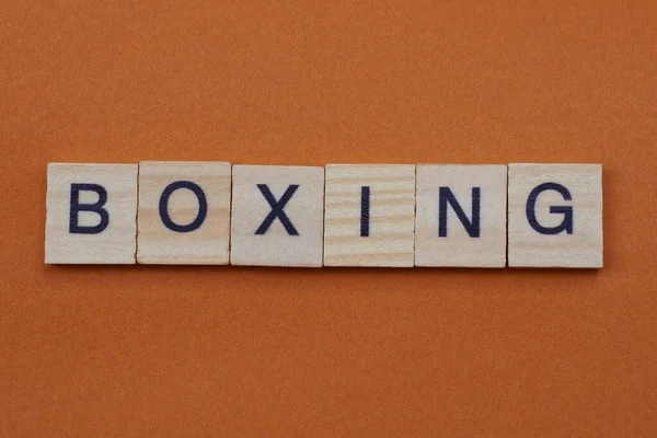 gray word boxing from small wooden letters on a brown table