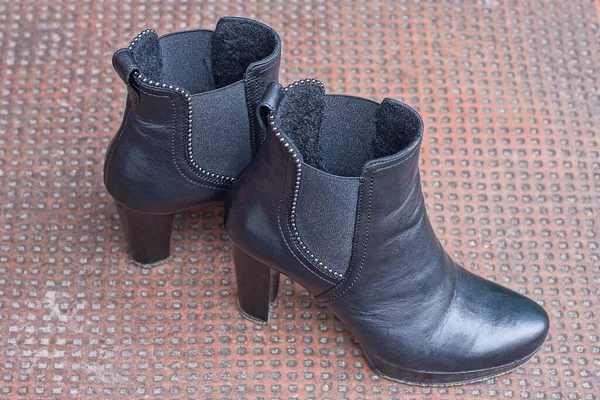 Two Black Women Leather Boots Stand Brown Table — 스톡 사진