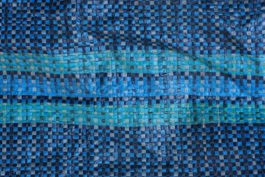 Eski bir torba üzerindeki kumaş parçasının renkli dokusu.