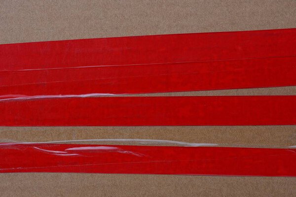 color texture of red electrical tape on brown paper