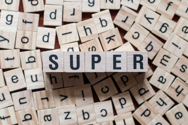 Super word written on wood block — Stock Photo, Image