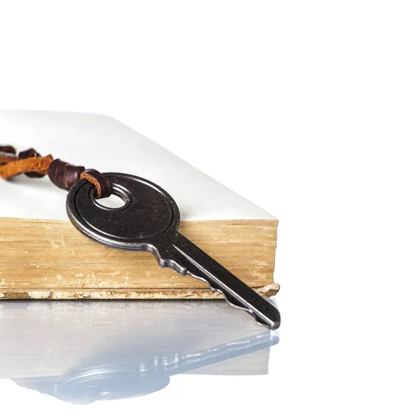 Key and Old Book on white background — Stock Photo, Image