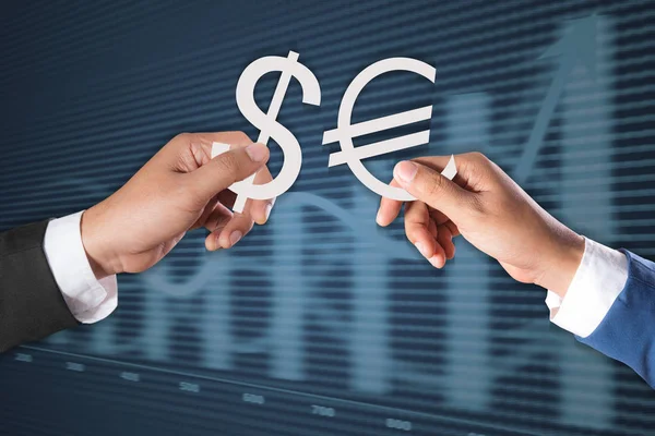 Dollar sign and Euro symbol on hand — Stock Photo, Image