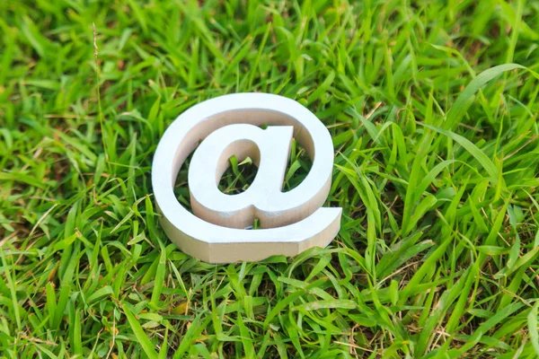 Email sign on green grass — Stock Photo, Image