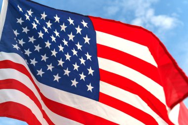 Yıldız ve çizgili mavi gökyüzüne Amerikan bayrağı sallayarak