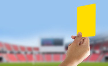 Referee showing yellow card in the field clipart