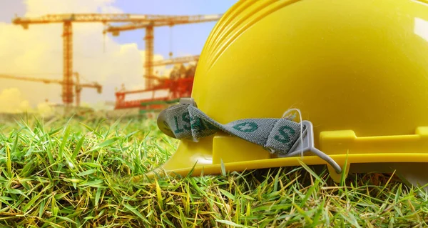 Yellow helmet and at construction site — Stock Photo, Image