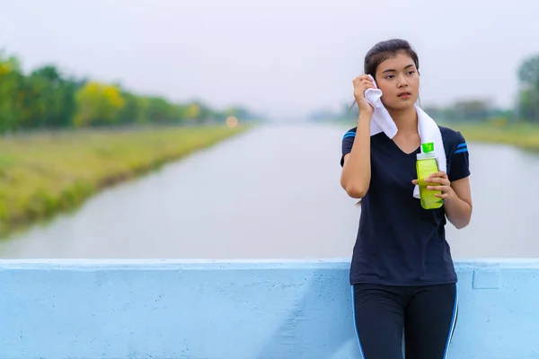 Portret van een mooi meisje in sportkleding met een fles wate — Stockfoto