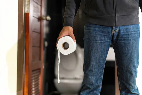 Man holding tissue roll in toilet — Stock Image Man holding tissue roll in toilet Stock Image