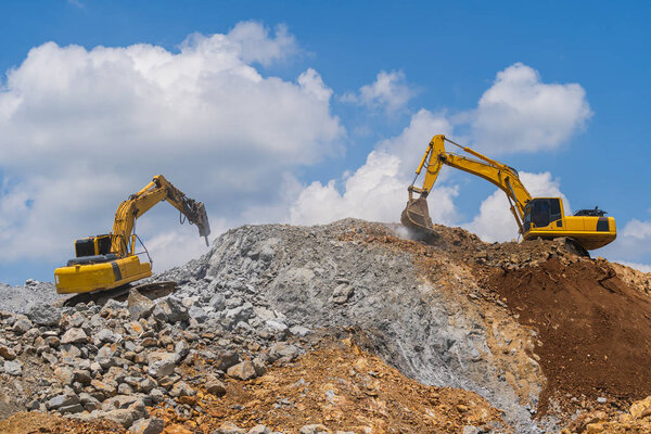 Excavator working outdoors under blue sky