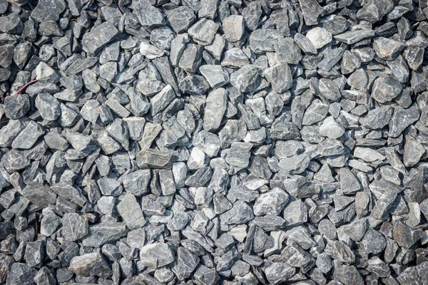 Grind grijs klein rots en steen textuur achtergrond. — Stockfoto