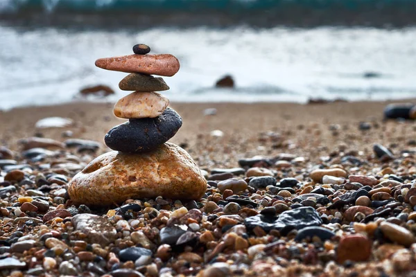 Six stones in balance by the sea