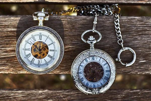 Vintage pocket watches on a wooden bench