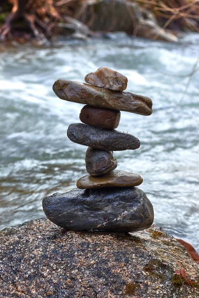 Seven balanced stones by the river