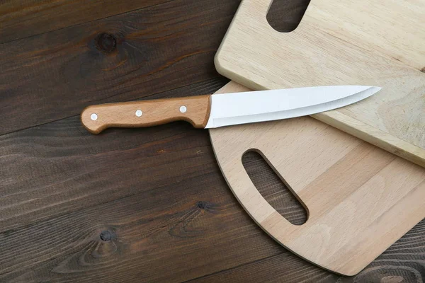 kitchen knife with a wooden handle on a cutting board with copy space