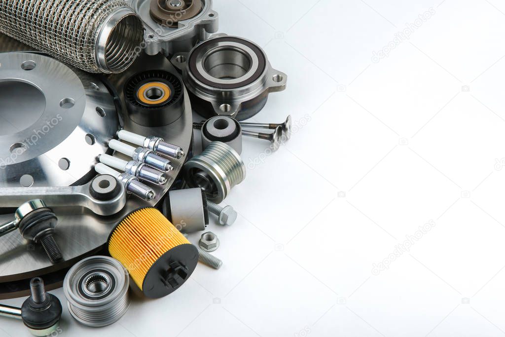 modern car parts on white background with copy space. pattern of set of auto spare parts with copy space