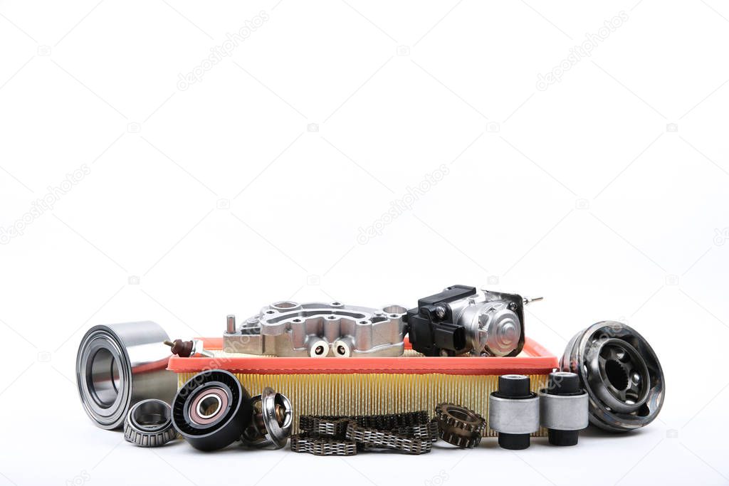 different car spare parts on white background with copy space