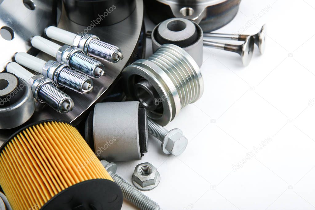 different modern car parts on white background with copy space