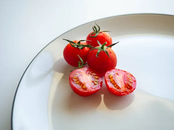Red tomatoes Put on dish White,Food for healthy,white background