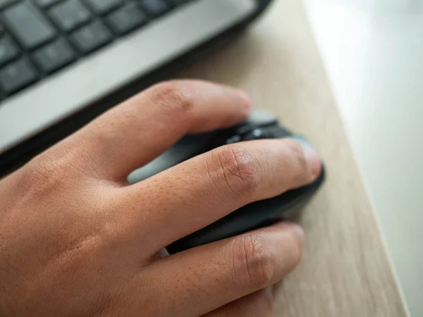 Woman's hand is pressing the Mouse,Work form home during the epidemic