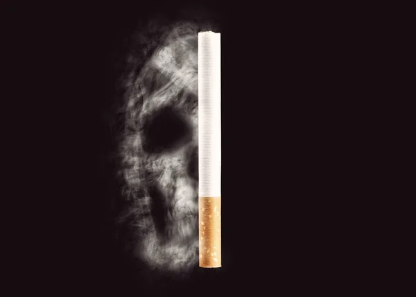 Skull from cigarette smoke on a black background. The concept of smoking kills, nicatine poisons, cancer. Stop smoking. Copy space.
