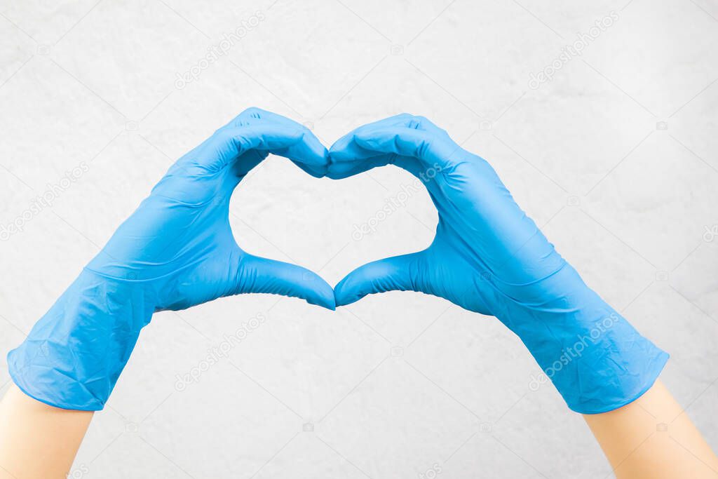 hands in medical gloves show a heart