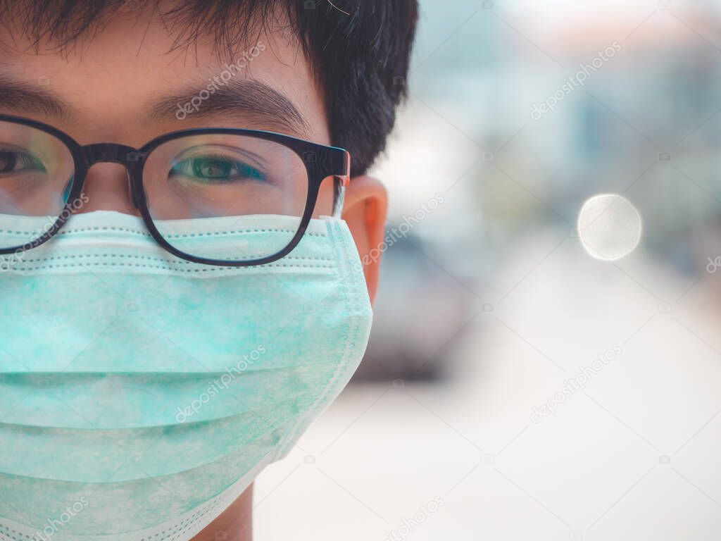 Little boy wearing mask for protect PM2.5, Coronavirus and smog when go to outside and stop Coronavirus outbreak.
