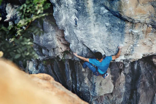 Man climbing a rock.