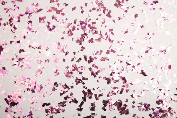 Kleurrijke confetti op een achtergrond. — Stockfoto