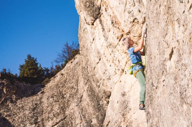 Kadın kayaya tırmanıyor..