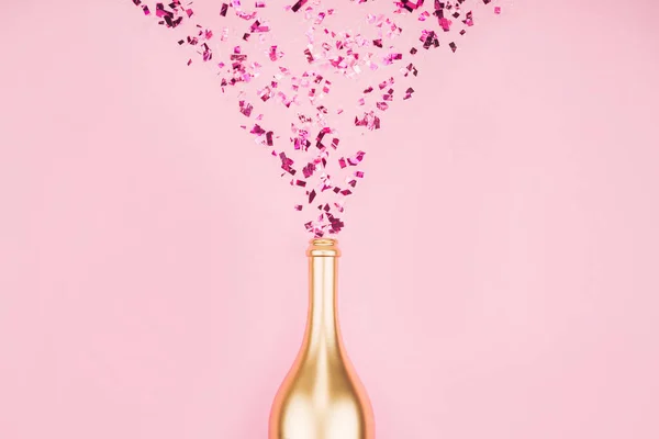 Bottle of champagne and confetti. — Stock Photo, Image