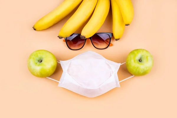 Fruit, sun glasses and mask composition.