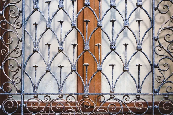 Ancient grate placed as protection in front of the window — Stock Photo, Image