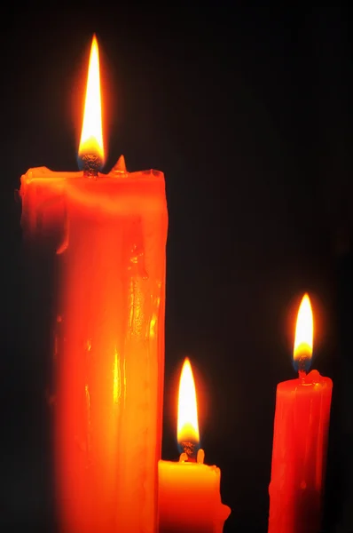 Red candle and lighting on black background — Stock Photo, Image