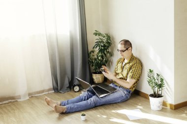 Genç adam evde çalışıyor..