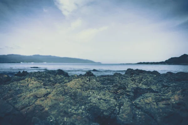 beach rock and stone to show with beach in background