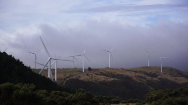 4K video of windmills farm for energy production at highland in New Zealand; Electricity production by windmills.