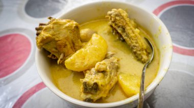 Ayam Masak Lemak Cili Api / Tavuk yahnisi hindistan cevizi sütü - geleneksel Malay mutfağı masada. Patates ve zerdeçal ekle. Ev yapımı yemek. Öğle yemeği için sıradan bir yemek. Baharatlı ve kremalı.