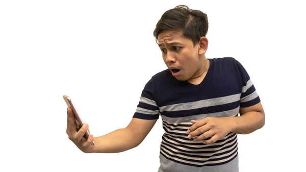 Wow and shocked face expression of young Asian Malay man of what he see in the smartphone on isolated white background.