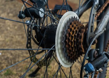 Close up view of the mountain bike rusty sprocket with gear and chain at the back tyre of bicycle due to poor maintenance. clipart