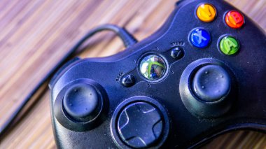 Bangi, Malezya - 24 Temmuz 2019: Ahşap masa arkaplanlı Xbox 360 Kontrolörünün görüntüsü.