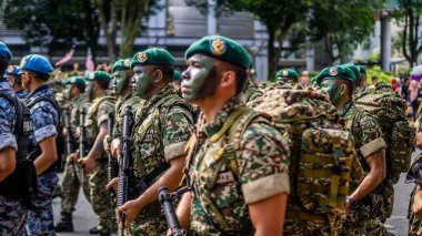 Putrajaya, Malaysia - August 31, 2019: The close up view of the parade contingent marching at the 62nd Independence day or Merdeka Day celebration of Malaysia in Putrajaya. clipart