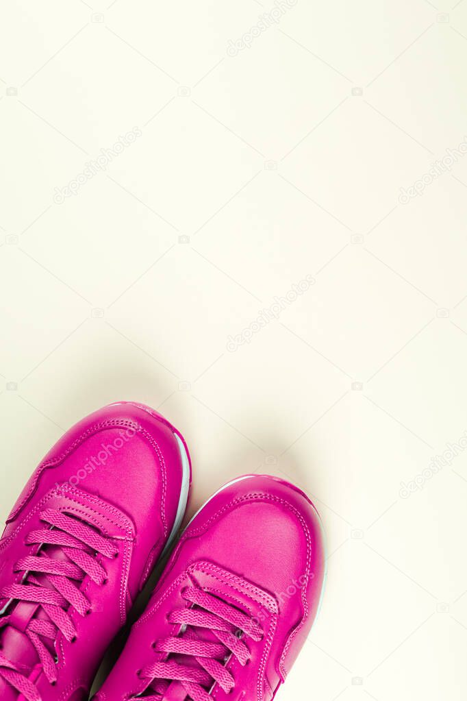 Bright pink sneakers on white background. Concept of sport and healthy lifestyle.