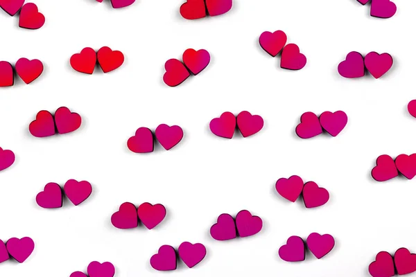 Muchos corazones rojos y rosados sobre fondo blanco . — Foto de Stock